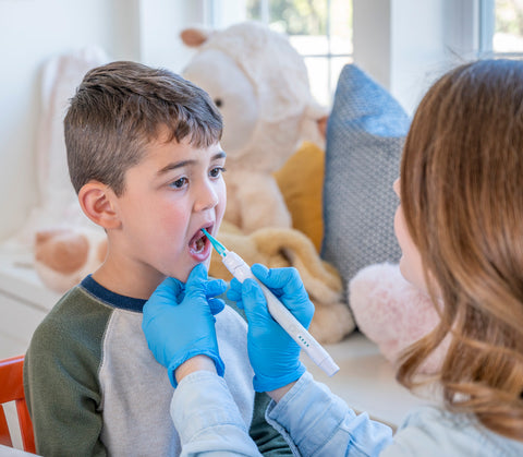 a small kid getting oral placement therapy